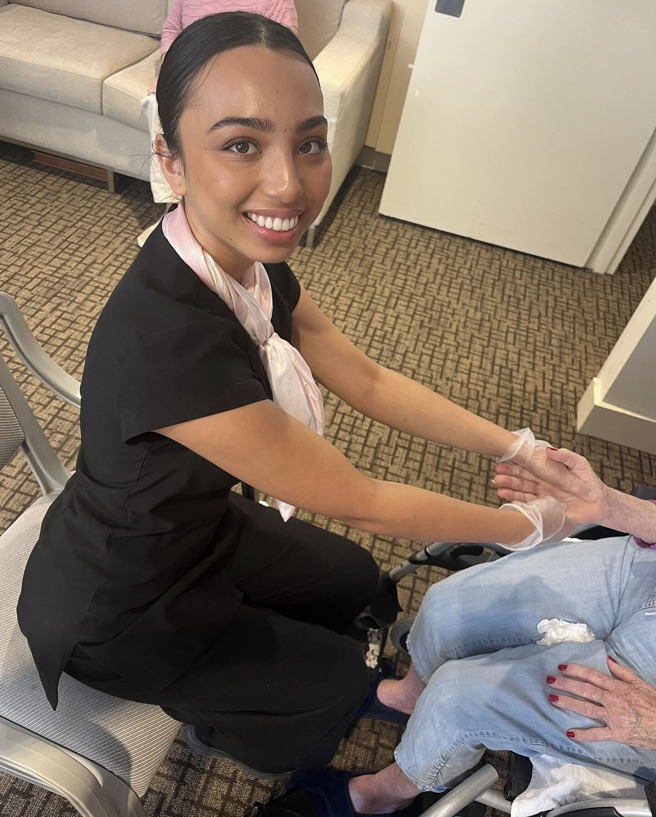 Image of a student performing a hand massage at an aged care clinic